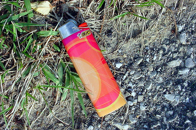 A Bic lighter laying on the ground