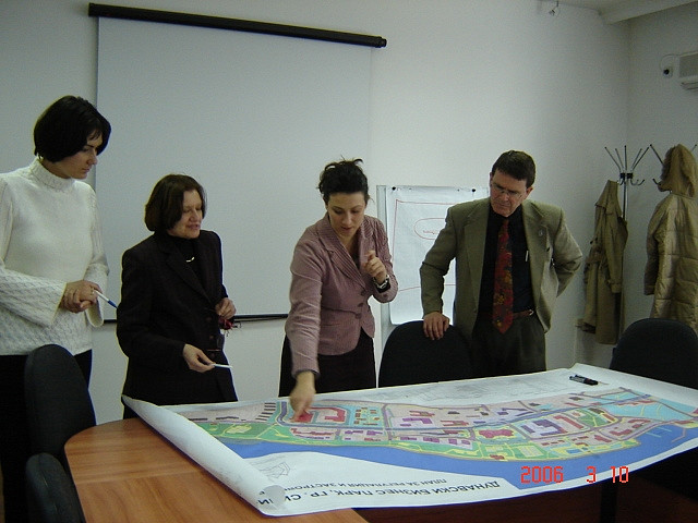 Employees overlooking a map of a town